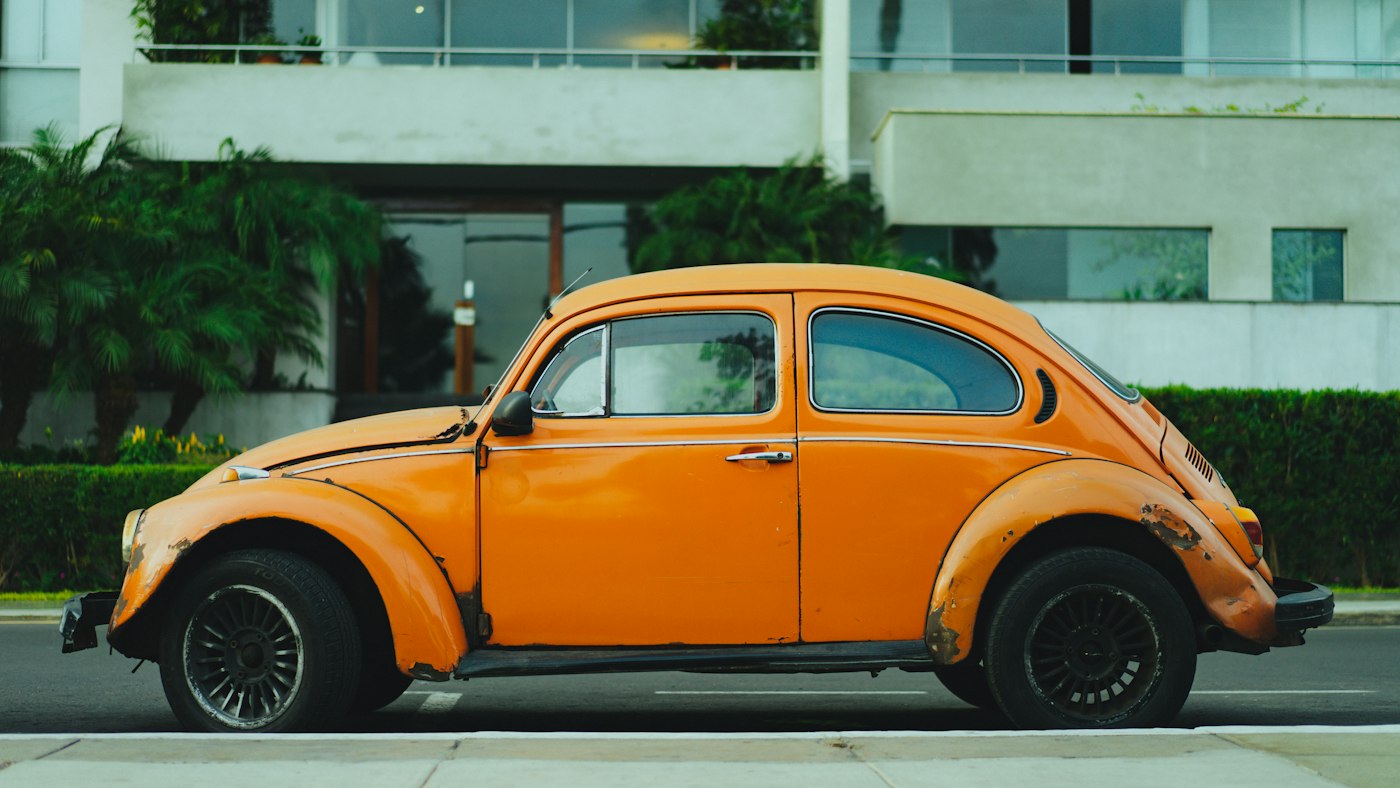 Orange classic car parked in daylight